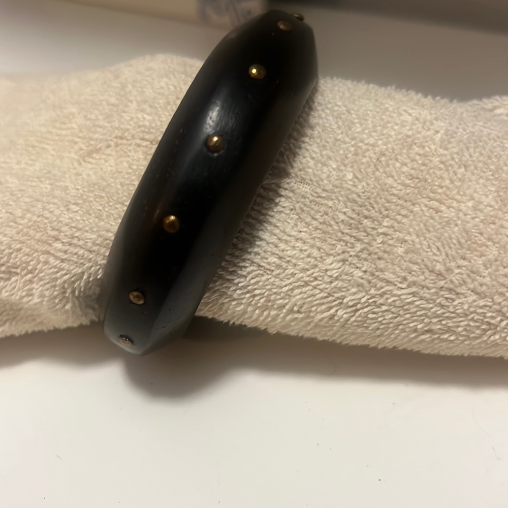 Black bangle bracelet with gold stud detail